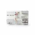 White pegboard organizer kit with hooks, baskets and shelves for craft room wall storage